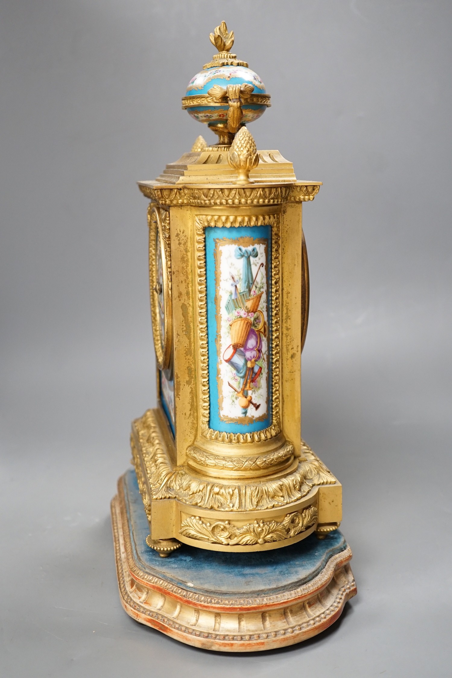 A French ormolu mantel clock, with inset floral decorated porcelain plaques and dial, 34cm high